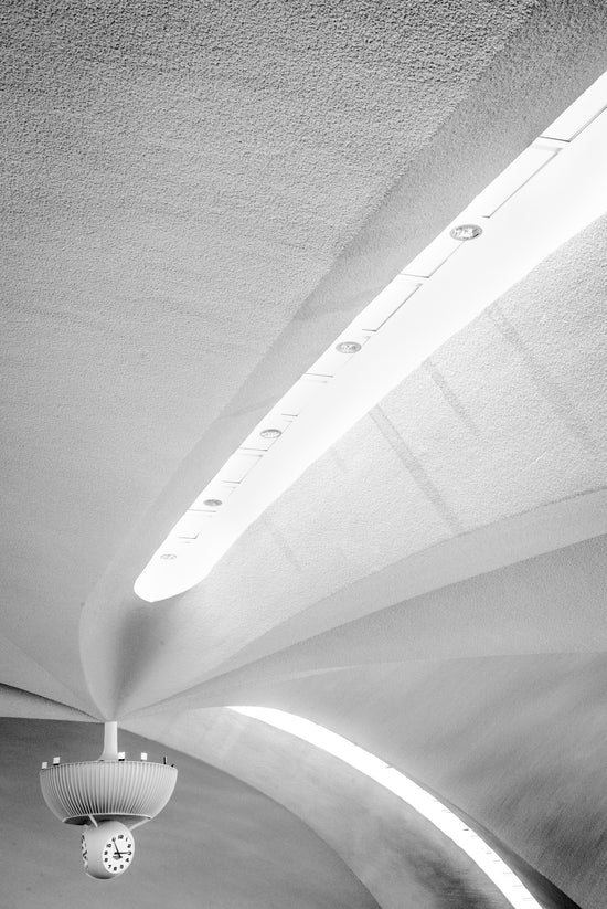 an image of a clock in an airport terminal