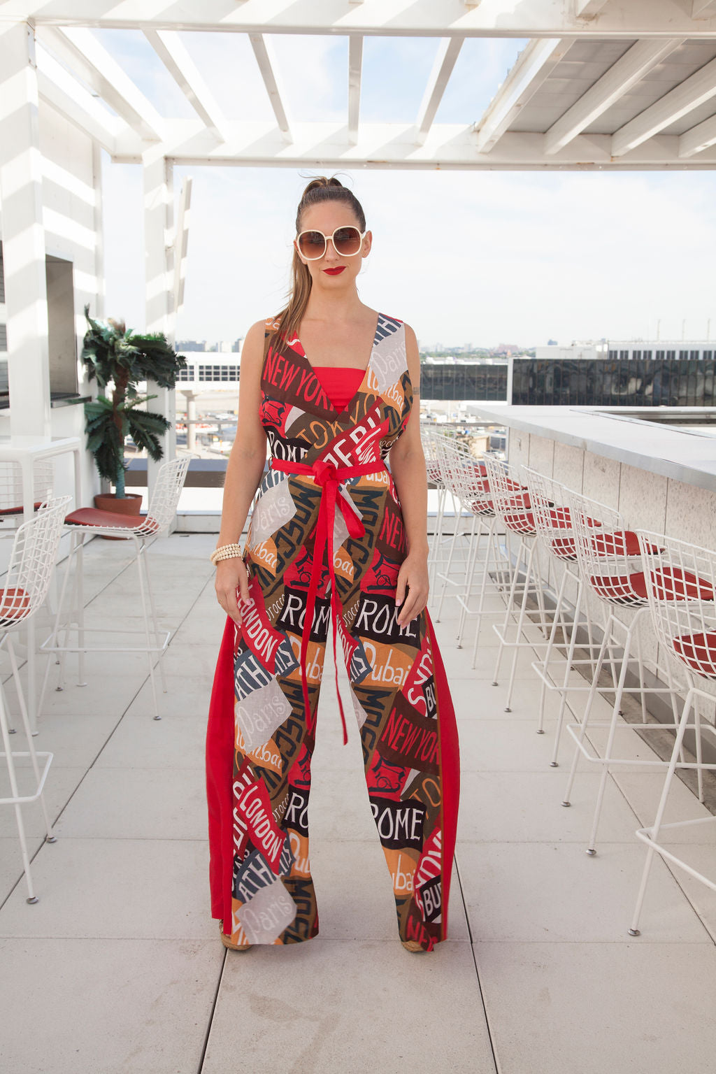 a woman in a romper stands in a restaurant 